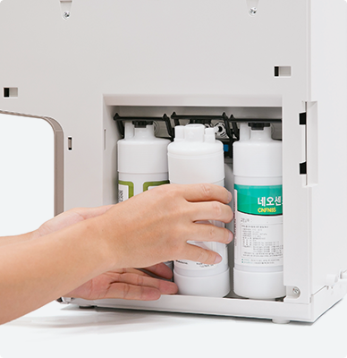 Technician replacing filter cartridges inside a Coway water purifier